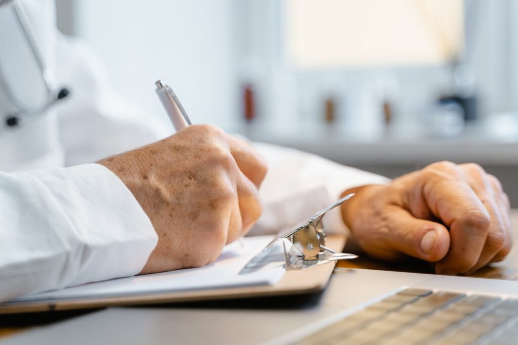 Mastering the First Impression: Your intriguing post title goes here Close-up of a doctor writing notes on a clipboard in a well-lit office.